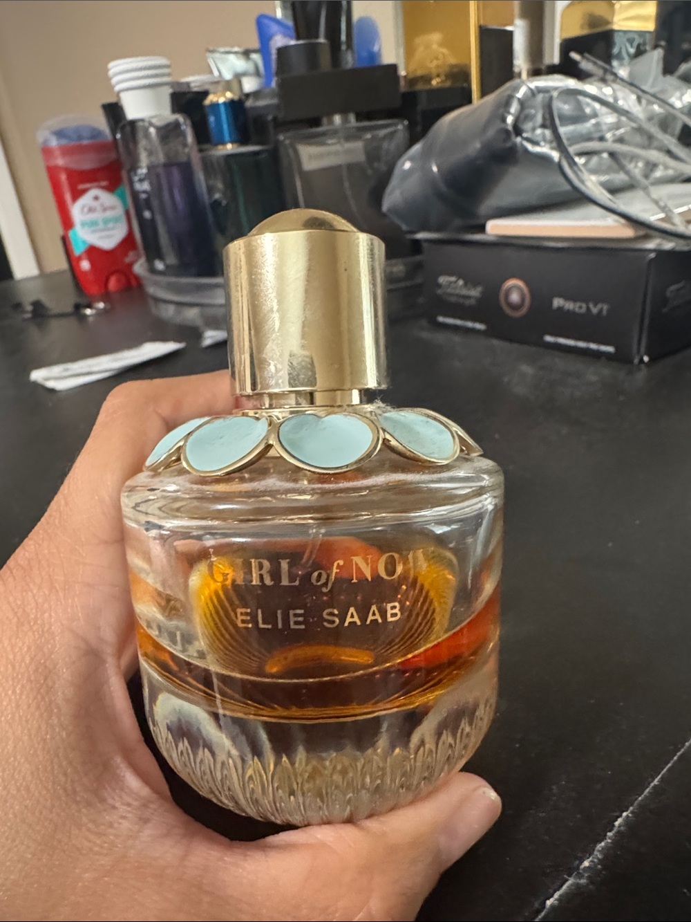 Elie Saab perfume bottle with gold and light blue accents